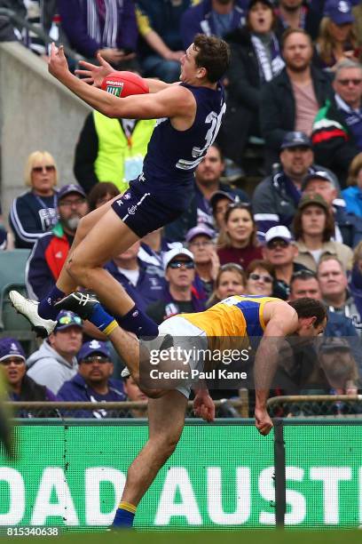 Brennan Cox of the Dockers contests a mark againstShannon Hurn of the Eagles during the round 17 AFL match between the Fremantle Dockers and the West...