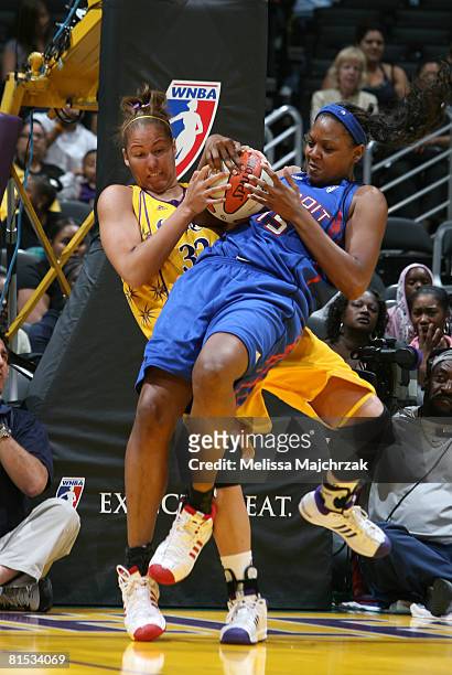 Christi Thomas of the Los Angeles Sparks tries to pull the ball away from Kara Braxton of the Detroit Shock during their game at Staples Center on...
