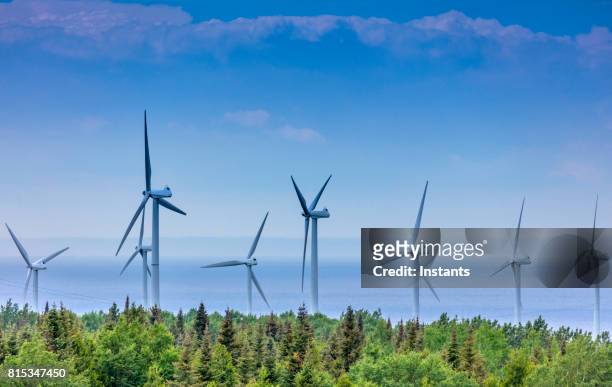 view of wind turbines near saint-lawrence river in la gaspésie region, situated in the canadian province of quebec. - quebec imagens e fotografias de stock