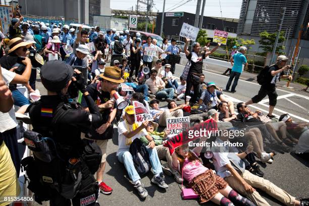 Anti-racist groups tried to block Japanese nationalists from marching on the street during a counter-protest rally demanding an end to hate speech in...