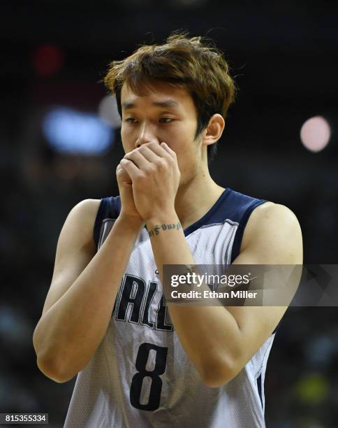 Ding Yanyuhang of the Dallas Mavericks blows on his hands during a 2017 Summer League game against the Boston Celtics at the Thomas & Mack Center on...