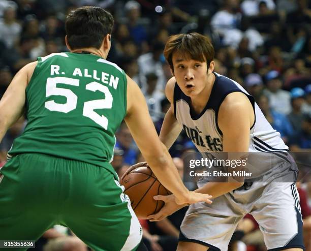 Ding Yanyuhang of the Dallas Mavericks is guarded by Rosco Allen of the Boston Celtics during the 2017 Summer League at the Thomas & Mack Center on...