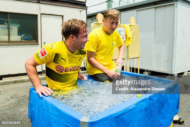 Mario Goetze and Felix Passlack of Borussia Dortmund are cooling down in the ice bath after a training session on July 16, 2017 in Tokyo, Japan.