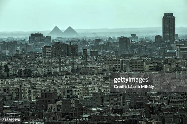 view from the citadel on the great pyramid complex of giza and the city center of cairo_2 - pyramid shapes around the house stock pictures, royalty-free photos & images