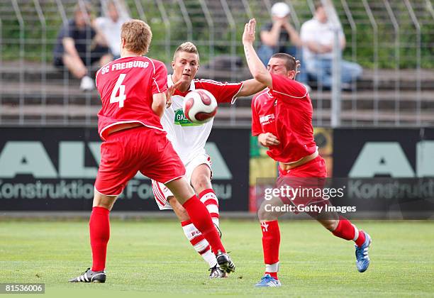 Nico Schlieter of Freiburg and Dennis Klossek of Freiburg attempt to tackle Dominik Schwerter of Koeln during the A Juniors semi final match between...