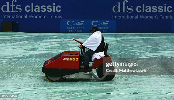 Groundsman soakes up water off Centre Court with a 'Water Hog' machine during the fourth day of the DFS Classic at the Edgsbaston Priory Club on June...