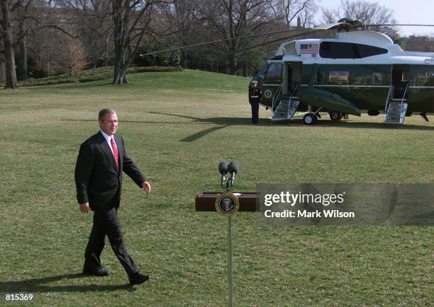 President George W. Bush walks over to the microphone to make a statement on the South Lawn of the White House in Washington D.C. March 8, 2001 about...