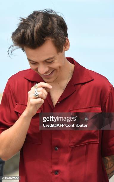 British singer, songwriter and actor Harry Styles reacts as he poses on July 16 during a photo-call in Dunkirk, ahead of the release of the movie...
