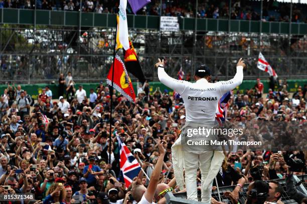 Race winner Lewis Hamilton of Great Britain and Mercedes GP celebrates with the fans after the Formula One Grand Prix of Great Britain at Silverstone...