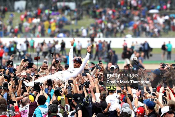 Race winner Lewis Hamilton of Great Britain and Mercedes GP celebrates with the fans after the Formula One Grand Prix of Great Britain at Silverstone...