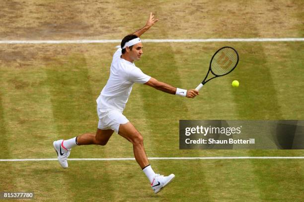 Roger Federer of Switzerland plays a backhand during the Gentlemen's Singles final against Marin Cilic of Croatia on day thirteen of the Wimbledon...