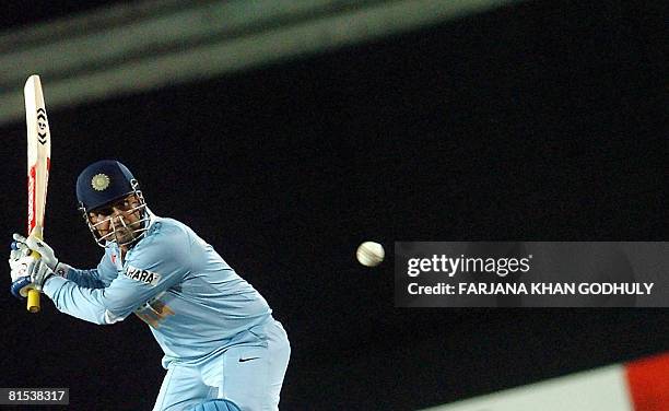 Indian cricketer Virender Sehwag hits a ball off the bowling of Bangladeshi bowler Dollar Mahmud during the third One Day International Tri-series...