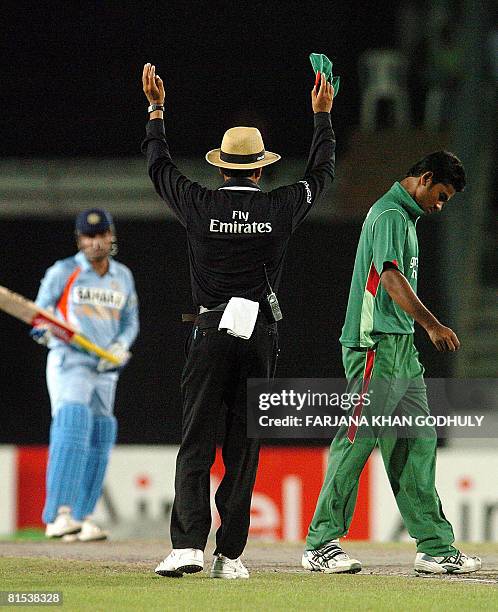 Bangladeshi bowler Dollar Mahmud looks dejected as Indian cricketer Virender Sehwag hits a six during the third One Day International Tri-series...
