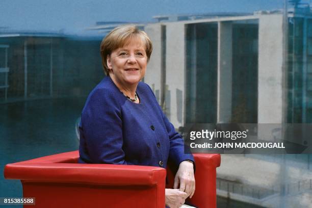 German Chancellor Angela Merkel poses for photographers before the recording of the traditional summer interview with public broadcaster TV station...