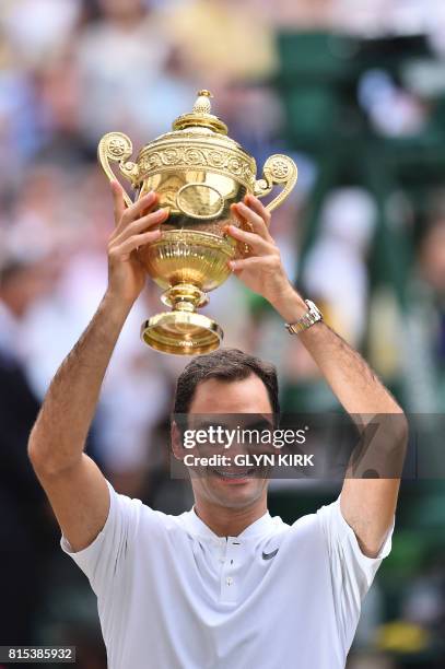 Switzerland's Roger Federer holds the winner's trophy after beating Croatia's Marin Cilic in their men's singles final match, during the presentation...