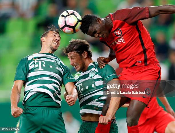 Paul Onuachu of FC Midtjylland competes for the ball in the air with Leandro De Almeida 'Leo' of Ferencvarosi TC and Bence Batik of Ferencvarosi TC...