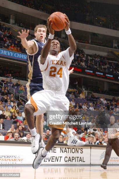 Royal Ivey of the Texas Longhorns drives to the basket during the BBT Classic college basketball game against the Notre Dame Fighting Irish at MCI...