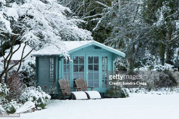 winter in the garden in the snow with the summer house - surrey england stock pictures, royalty-free photos & images