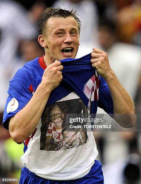 Croatian forward Ivica Olic celebrates and shows the piture of two children on his t-shirt after scoring the second goal during their Euro 2008...