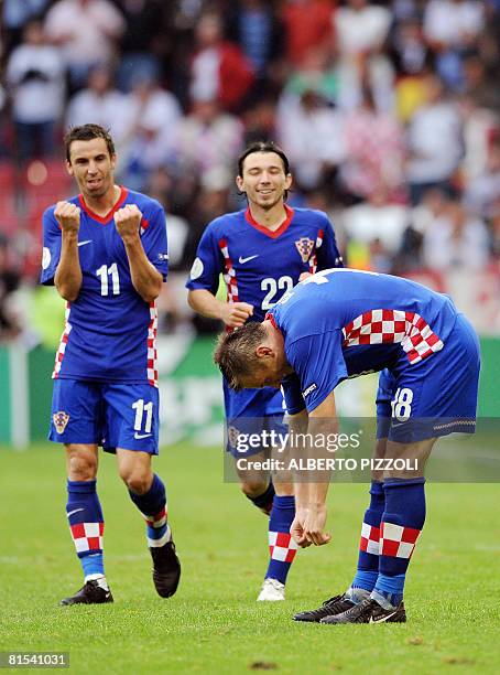 Croatian forward Ivica Olic reacts to scoring against Germany as teammates Croatian midfielders Darijo Srna and Danijel Pranjic celebrate during...