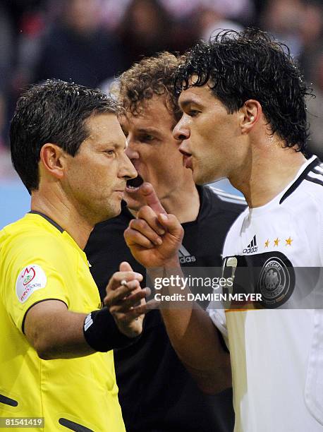 Belgian referee Frank De Bleeckere argues with German midfielder Michael Ballack next to German goalkeeper Jens Lehmann after he gave a red card to...