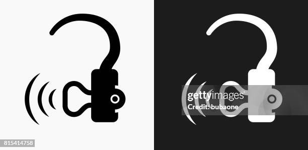 hearing aid icon on black and white vector backgrounds - hearing loss stock illustrations