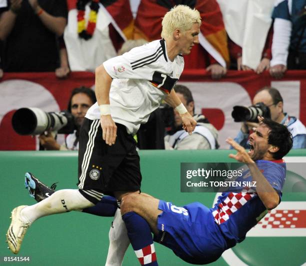 Germany's midfielder Bastian Schweinsteiger fouls Croatian midfielder Jerko Leko during their Euro 2008 Championships Group B football match Croatia...