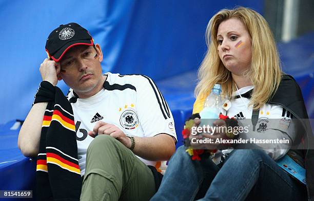 Germany fans look dejected after losing the UEFA EURO 2008 Group B match between Croatia and Germany at Worthersee Stadion on June 12, 2008 in...