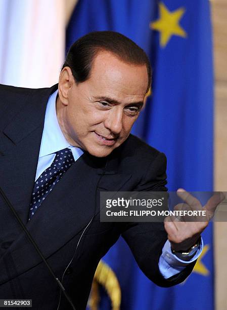 Italian Prime Minister Silvio Berlusconi gestures during a joint press conference with US President George W. Bush at Villa Madama in Rome on June...