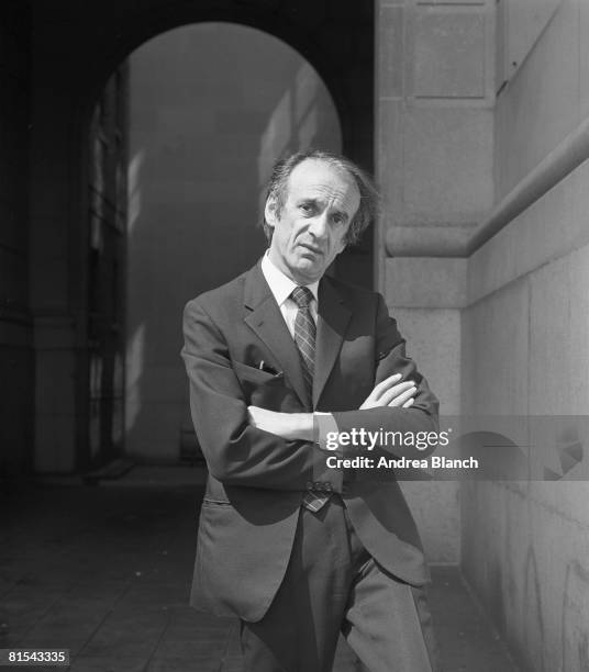 Portrait of Nobel Prize-winning author and Holocaust survivor Elie Wiesel, as he poses in a suit with arms folded, 1983.