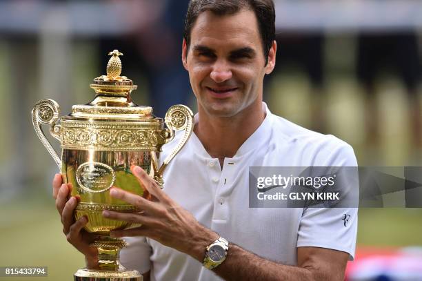 Switzerland's Roger Federer holds the winner's trophy after beating Croatia's Marin Cilic in their men's singles final match, during the presentation...