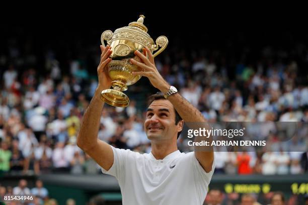 Switzerland's Roger Federer holds the winner's trophy after beating Croatia's Marin Cilic in their men's singles final match, during the presentation...
