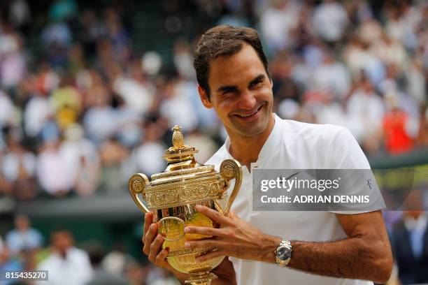 Switzerland's Roger Federer holds the winner's trophy after beating Croatia's Marin Cilic in their men's singles final match, during the presentation...