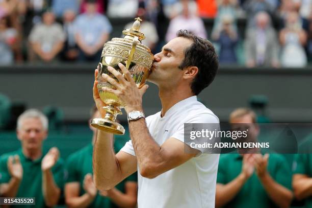 Switzerland's Roger Federer kisses the winner's trophy after beating Croatia's Marin Cilic in their men's singles final match, during the...