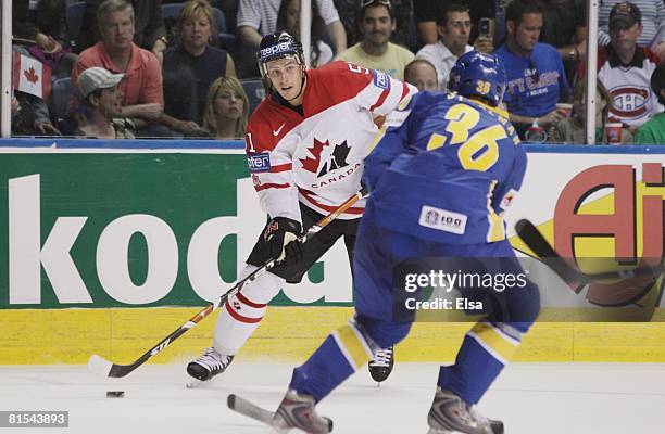 Ryan Getzlaf of Canada plays the puck against Anton Stralman of Sweden during the Semifinal round of the International Ice Hockey Federation World...