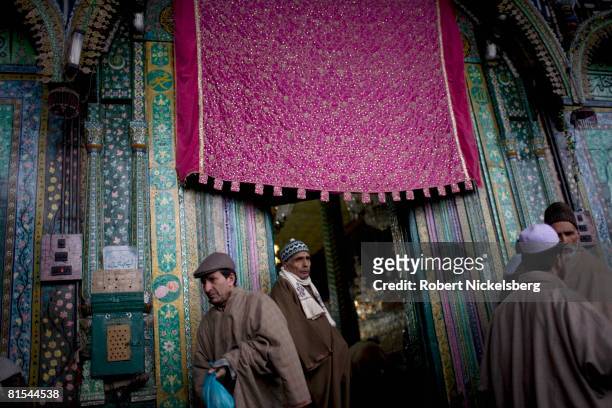 Kashmiri men exit after praying inside the elaborately decorated Shah-i-Hamadan shrine on January 16, 2008 in Srinagar, Kashmir. The wooden structure...