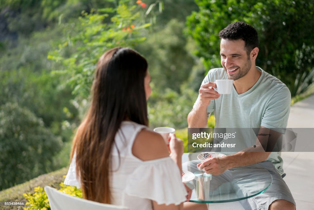 Voyage des couples ayant une tasse de café à l’hôtel