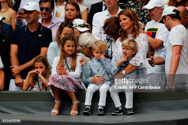 Mirka Federer, wife of Switzerland's Roger Federer, stands with her children Charlene Riva, Myla Rose, Lenny and Leo, as her husband holds the...