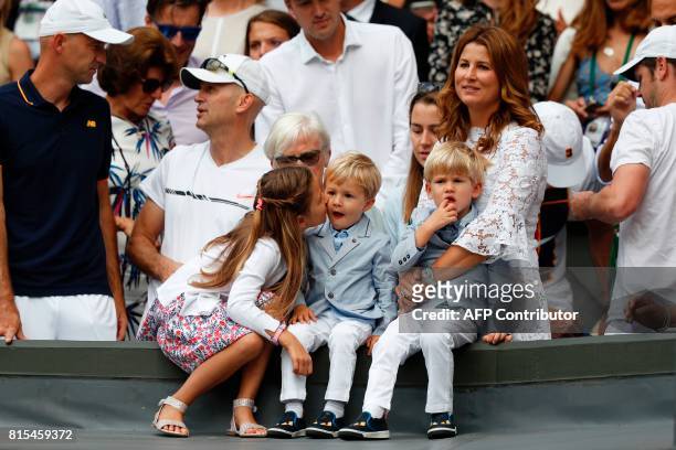 Mirka Federer, wife of Switzerland's Roger Federer, stands with her children Charlene Riva, Myla Rose, Lenny and Leo, as her husband holds the...