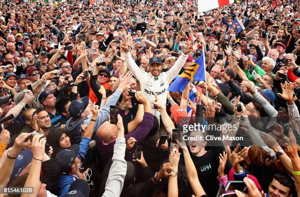 Race winner Lewis Hamilton of Great Britain and Mercedes GP celebrates with the fans after the Formula One Grand Prix of Great Britain at Silverstone...