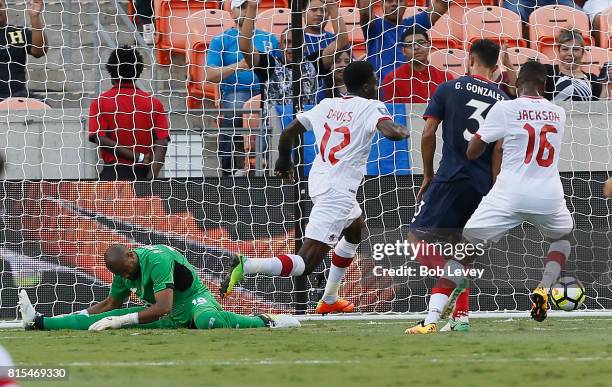 Alphonso Davies of Canada scores as he beats Patrick Pemberton of Costa Rica at BBVA Compass Stadium on July 11, 2017 in Houston, Texas.