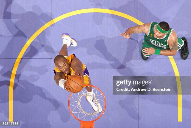 Kobe Bryant of the Los Angeles Lakers goes up for a dunk while Eddie House of the Boston Celtics looks on in Game Four of the 2008 NBA Finals at...