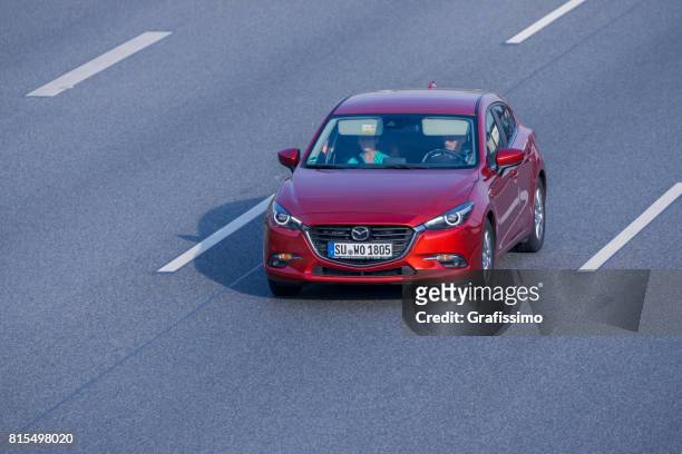 mazda rossa alla guida su un'autostrada a più corsie tedesca - multiple lane highway foto e immagini stock
