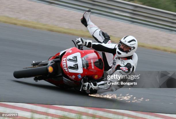 Former Formula One world champion Michael Schumacher falls from his bike during a test ride of the Superbike International German Championship, IDM,...