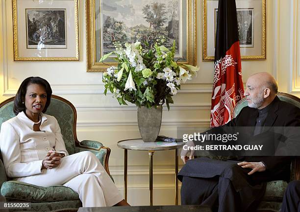 Secretary of State Condoleezza Rice, talks with Afghan President Hamid Karzai on June 13, 2008 during a meeting at the US Embassy in Paris. US...