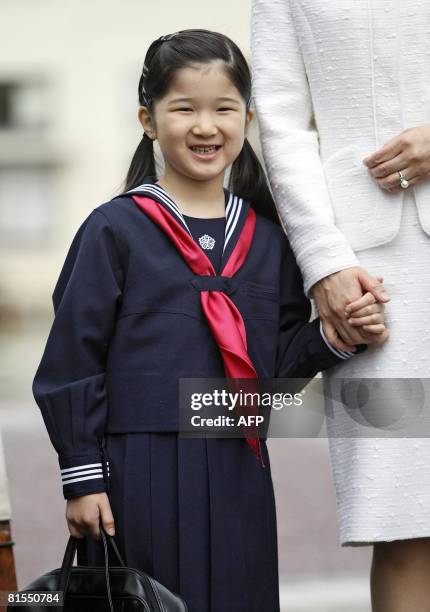 Six-year-old Japanese Princess Aiko , accompanied by her mother Crown Princess Masako , smiles as she arrives to attend her entrance ceremony at the...