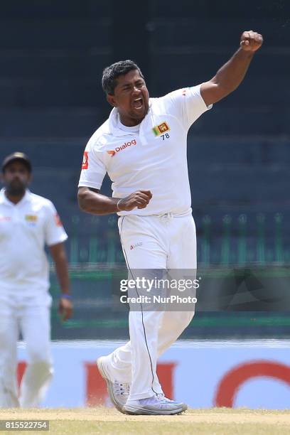 Sri Lanka's Rangana Herath celebrates taking the wicket of Zimbabwe's Hamilton Masakadza during the third day's play of the only test cricket match...