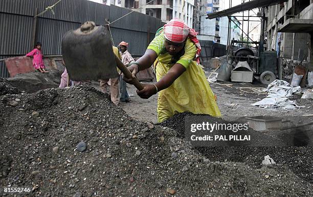 An Indian labourer works at a construction site in Mumbai on June 13, 2008. India's inflation hit its highest level in over seven years, stoking...