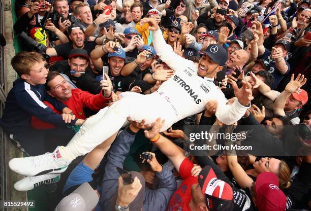 Race winner Lewis Hamilton of Great Britain and Mercedes GP celebrates with the fans after the Formula One Grand Prix of Great Britain at Silverstone...