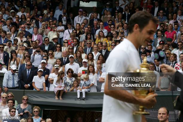 Mirka Federer, wife of Switzerland's Roger Federer, stands with their children Charlene Riva, Myla Rose, Lenny and Leo, as her husband holds the...